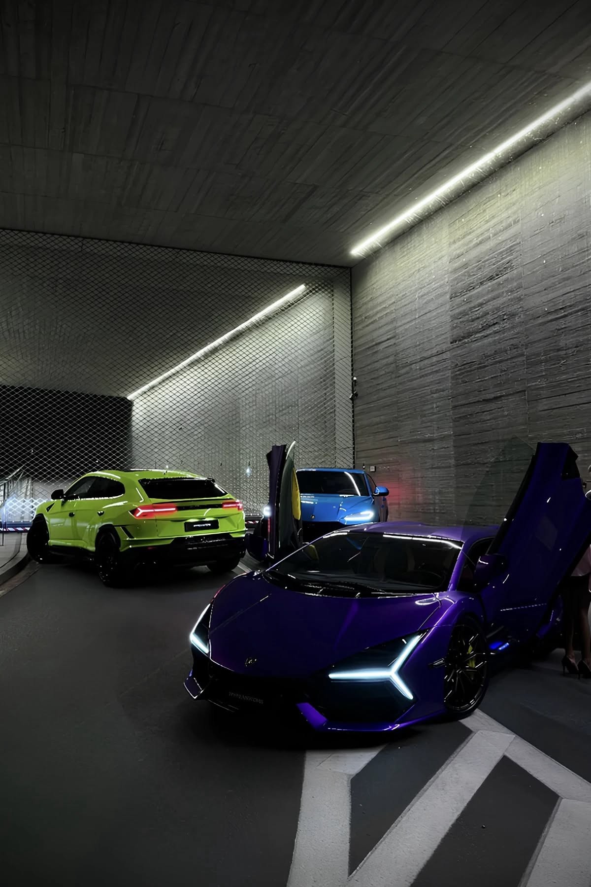 Purple supercar with doors up in a concrete parking structure