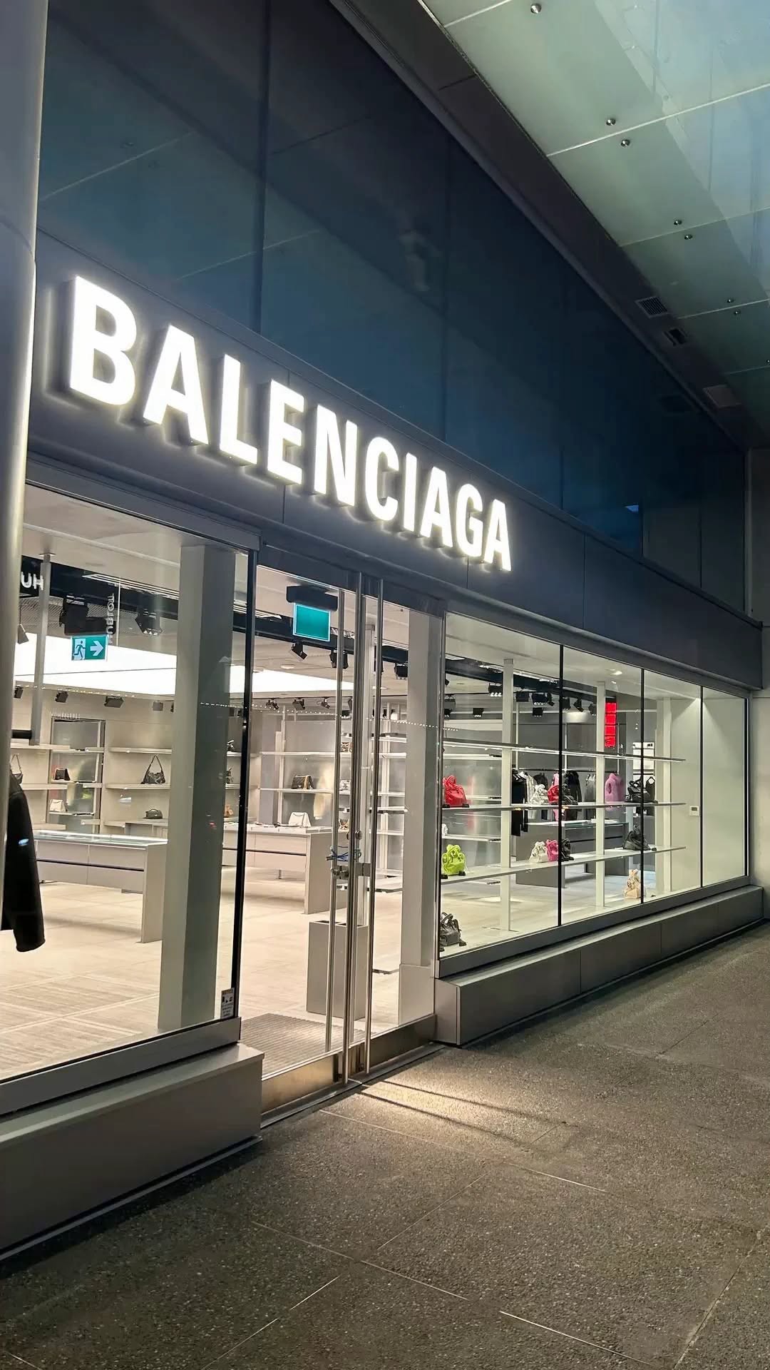 Lit designer storefront at night with glass display windows