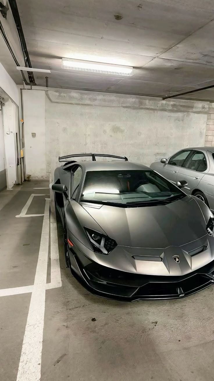 Grey supercar parked in an underground garage